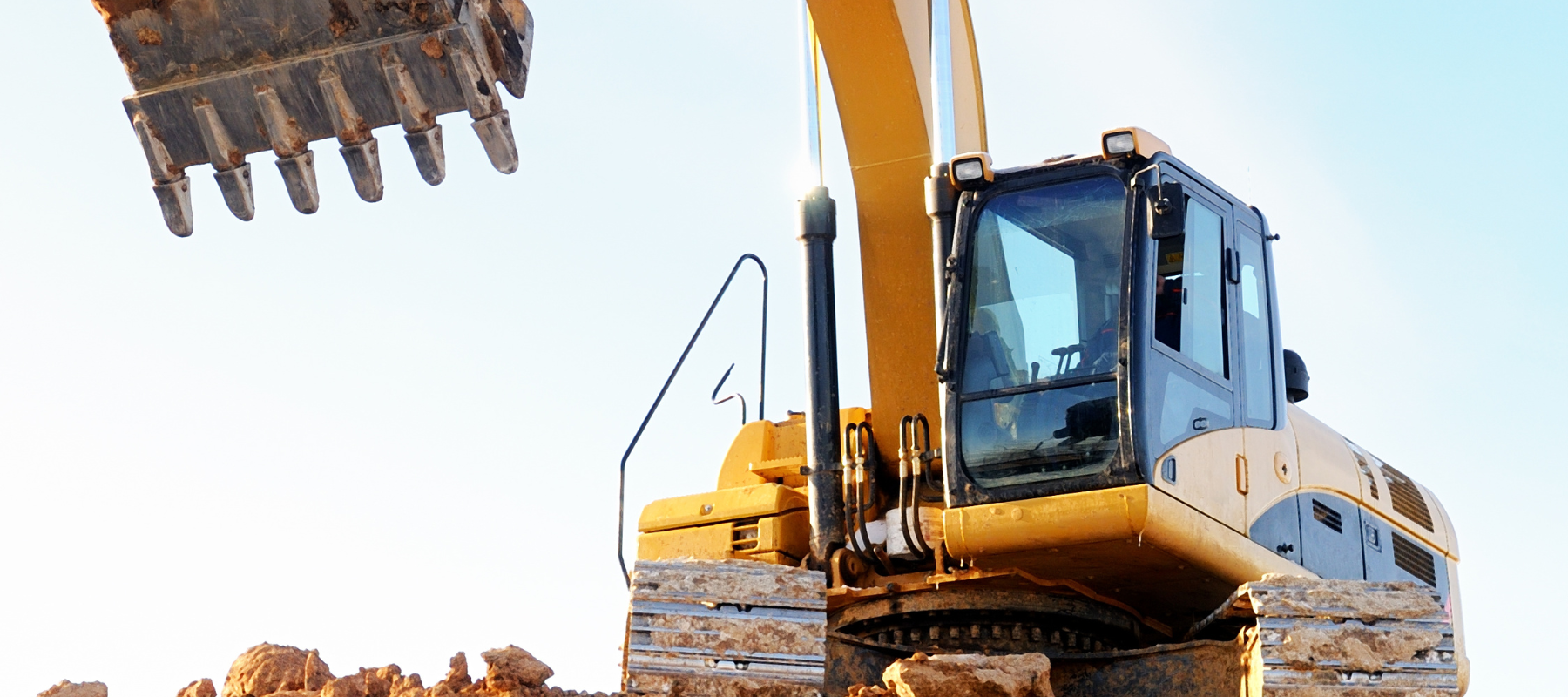 Yellow loader working on a clear day